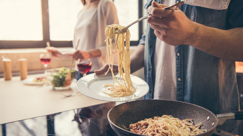 couple cooking dinner in kitchen