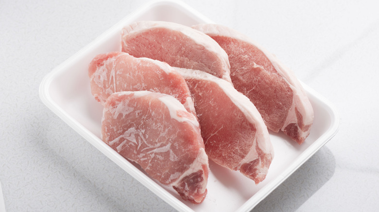 Frozen pork chops in container