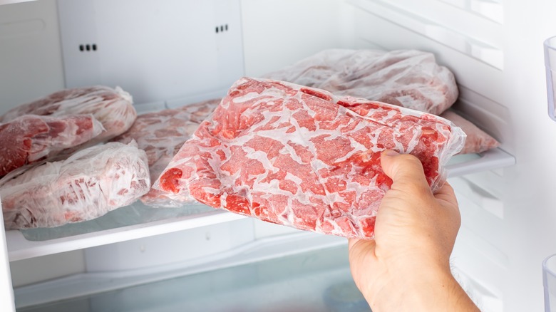 Putting meat on freezer shelf