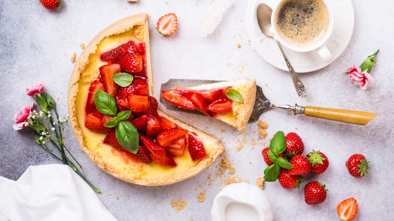 cake topped with strawberries, basil