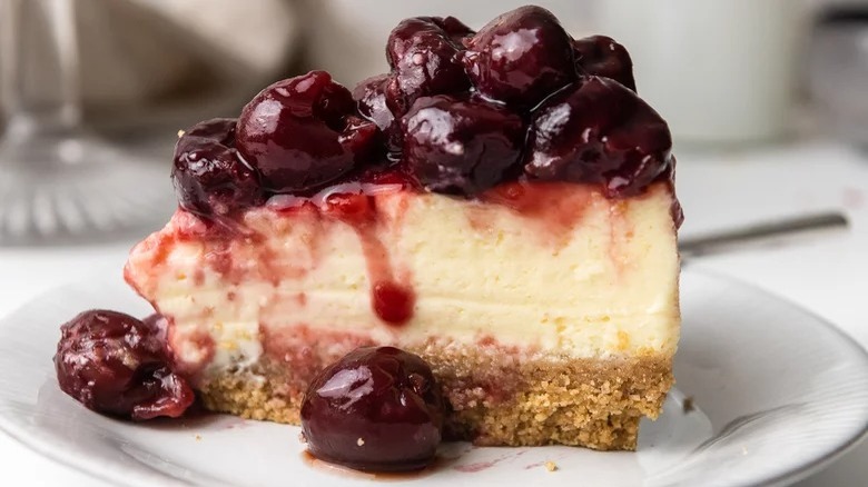 Cheesecake slice topped with cherries