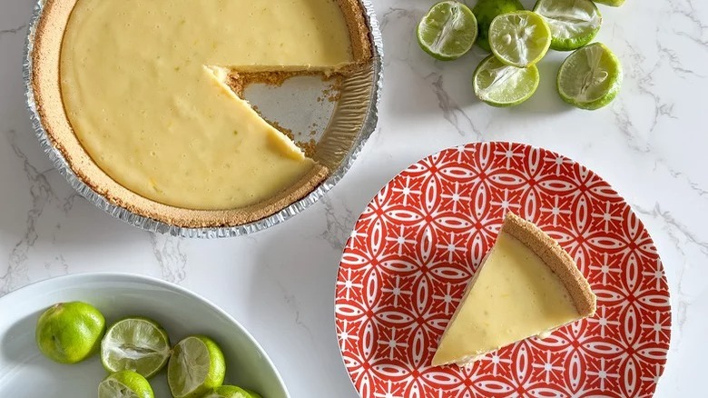 Key lime pie slice with limes