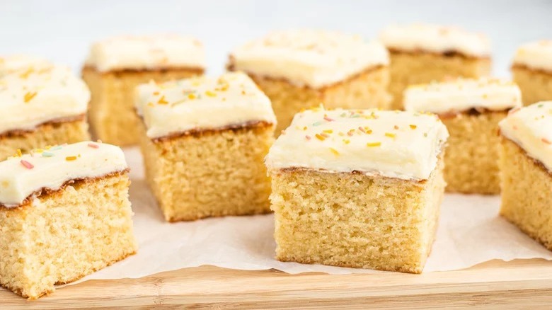 Squares of iced vanilla sheet cake