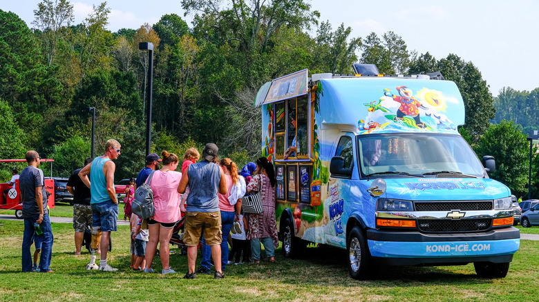 kona ice truck in field with line