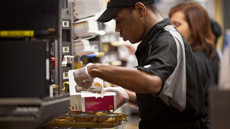 McDonald's employee making Chicken McNuggets