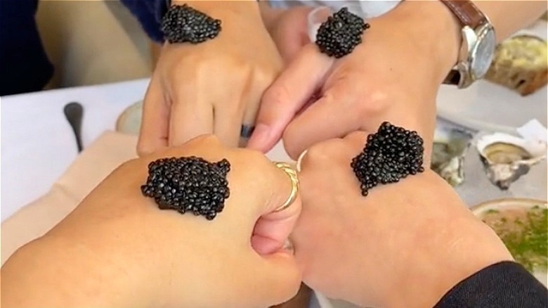 hands holding caviar bumps