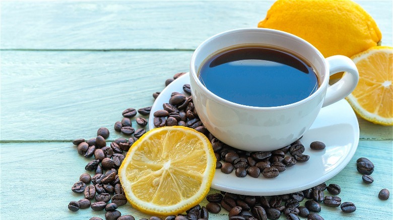 cup of black coffee with lemons