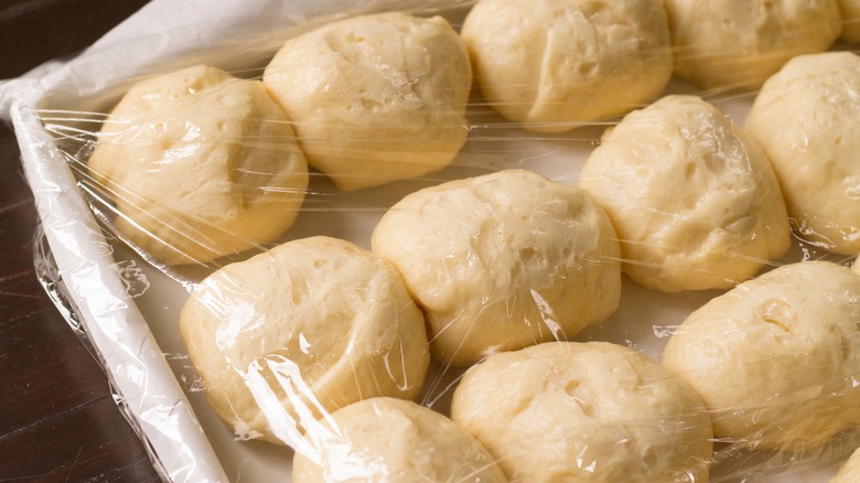 Dough balls under plastic wrap