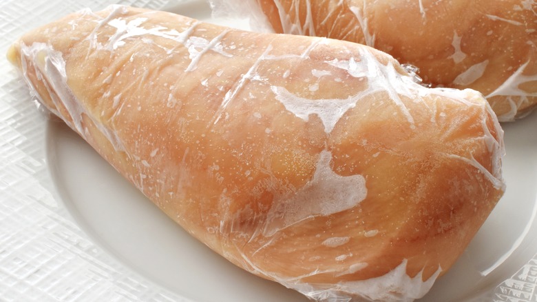 frozen chicken in plastic wrap