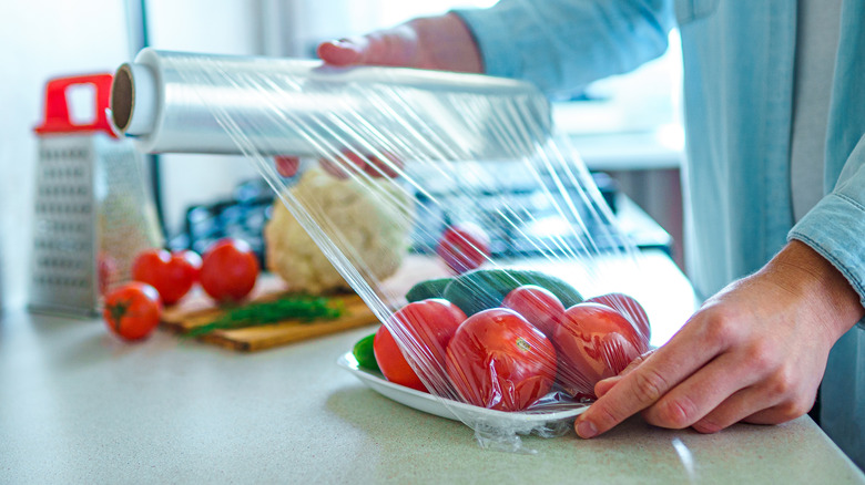 vegetables being wrapped in plastic