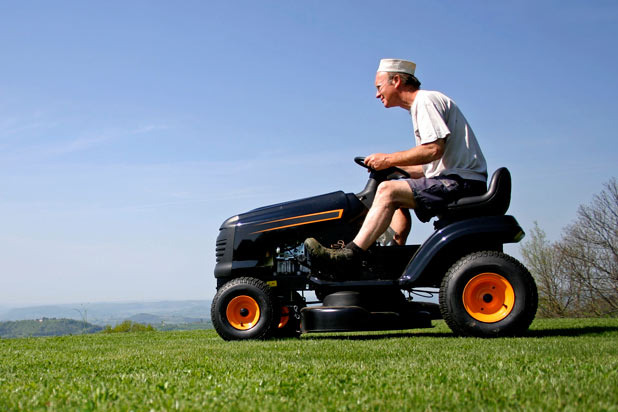 Man Drinks Whiskey While Riding His Lawnmower Down the Street