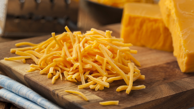 shredded orange cheese on board