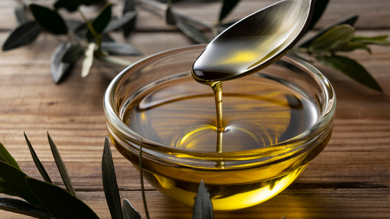 Olive oil falling off a spoon