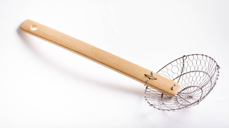 Spider strainer on white background