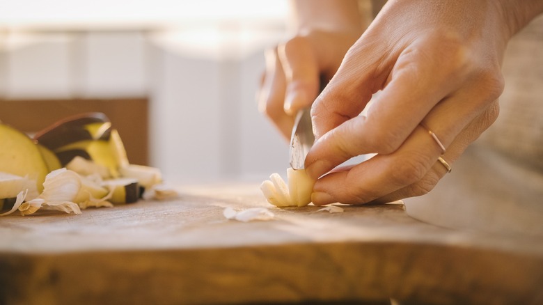 Woman chopping garlic