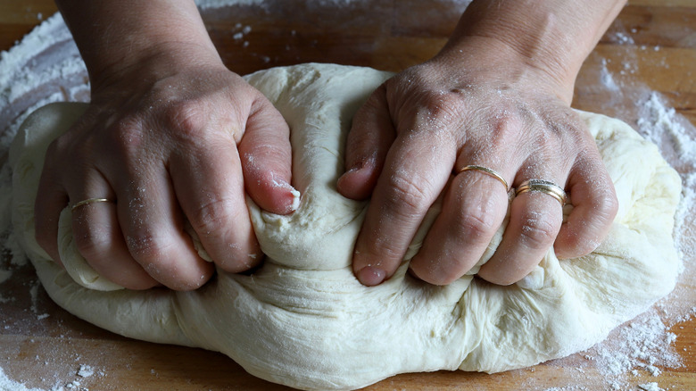 hands kneading pie dough