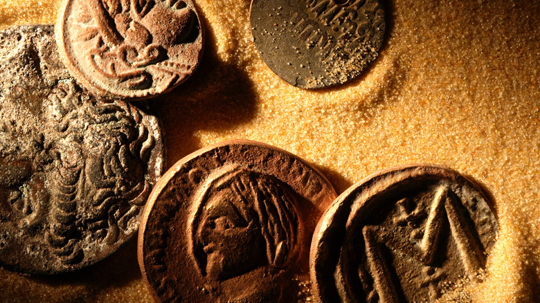 old coins on sand 