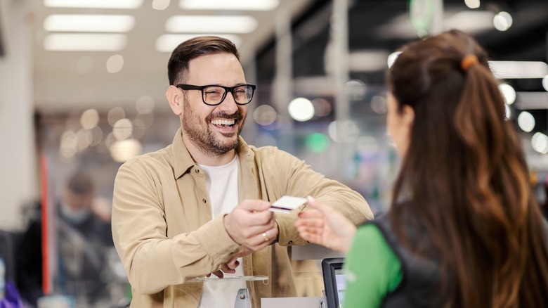 man paying with credit card