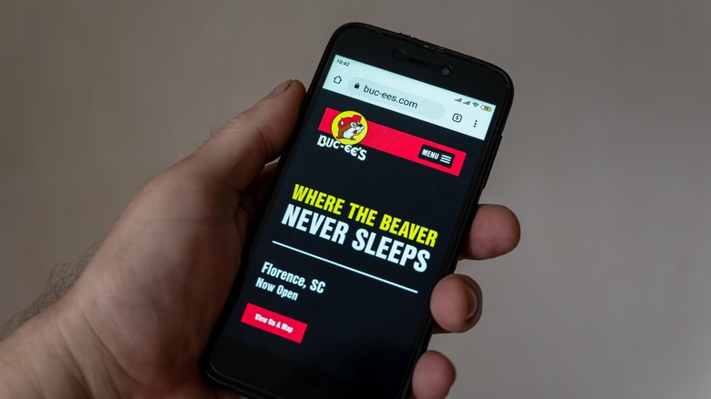 smartphone with Buc-ee's on screen