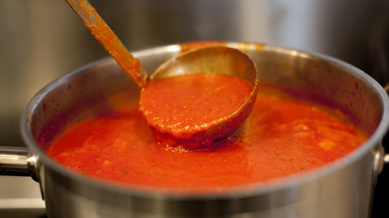 Marinara sauce in ladle