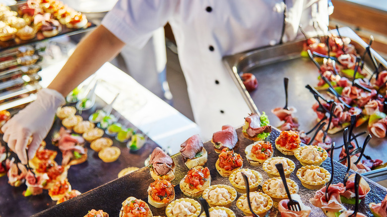 caterer refilling food trays