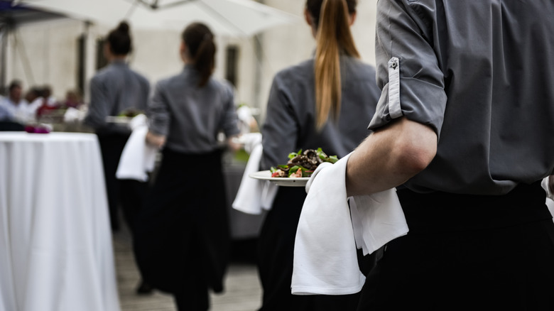 waiters carrying dishes