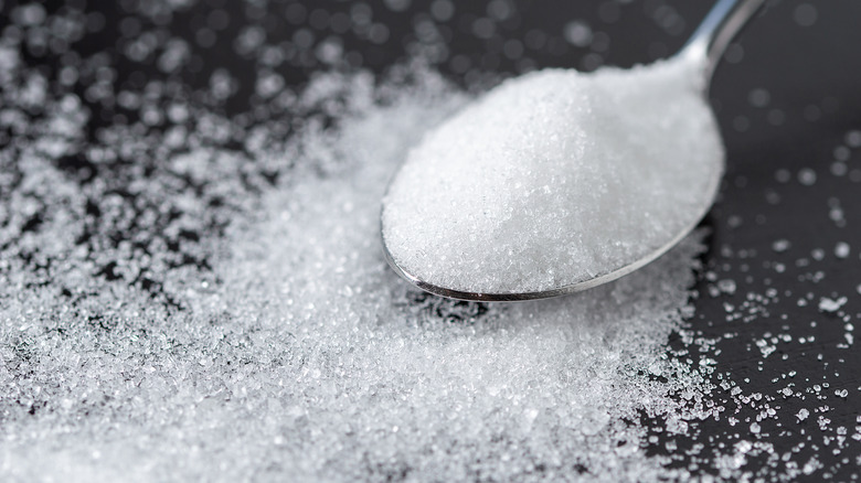 close up of sugar on a metal spoon