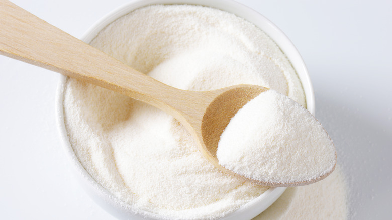 bowl of powdered milk and wooden spoon