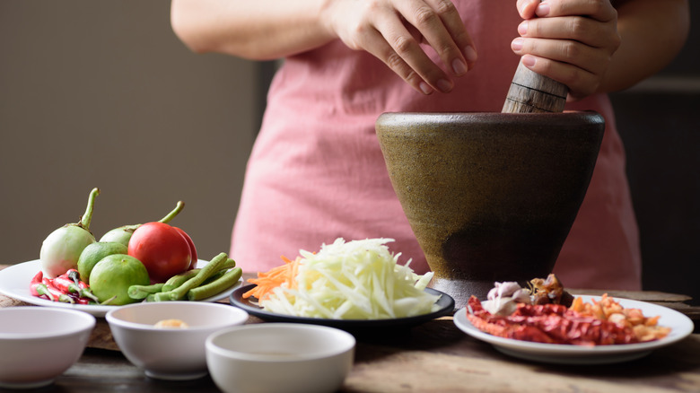 Thai ingredients being combined in bowl