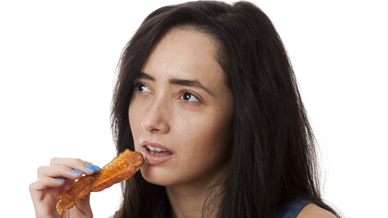 Woman eating bacon