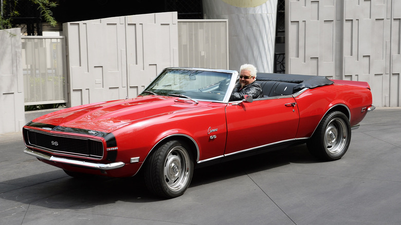 Guy Fieri  in red camaro 