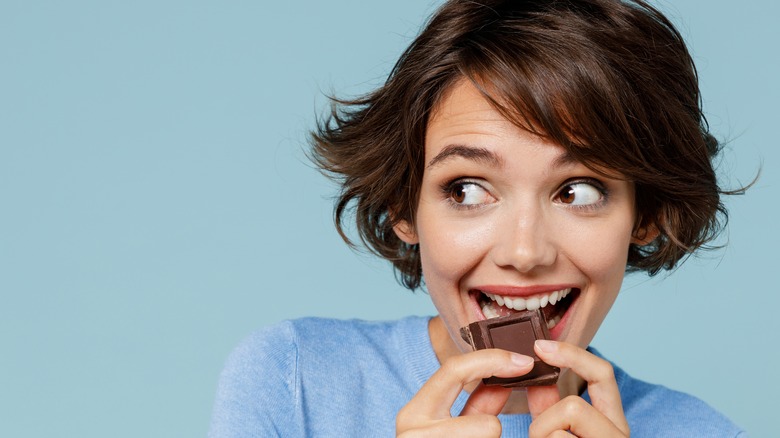 women eating a chocolate bar