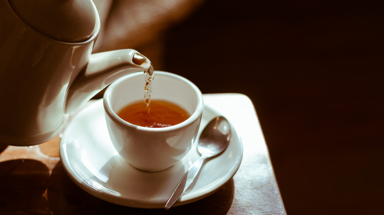 Tea kettle pouring into mug