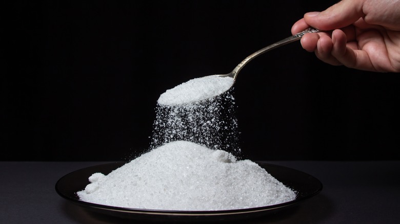 salt being poured from spoon