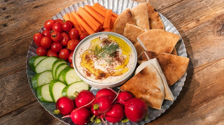 Hummus served with vegetables and bread