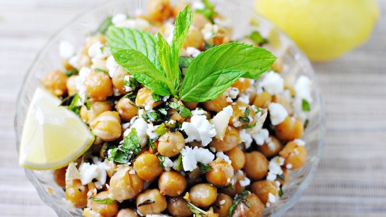 Bowl of garlicky roasted chickpeas with feta and fresh mint