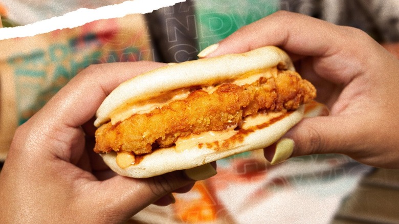 Hands holding Taco Bell chicken taco