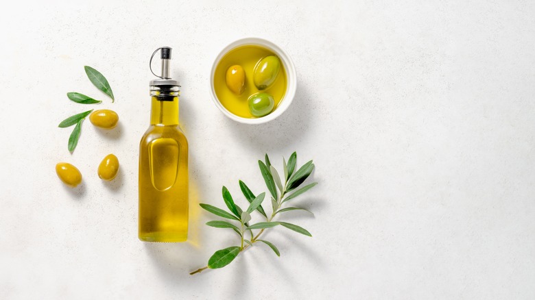 Olive oil bottle and olives