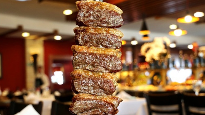 Slices of grilled Picanha on a spit