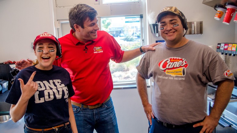 Raising Cane's founder with employees