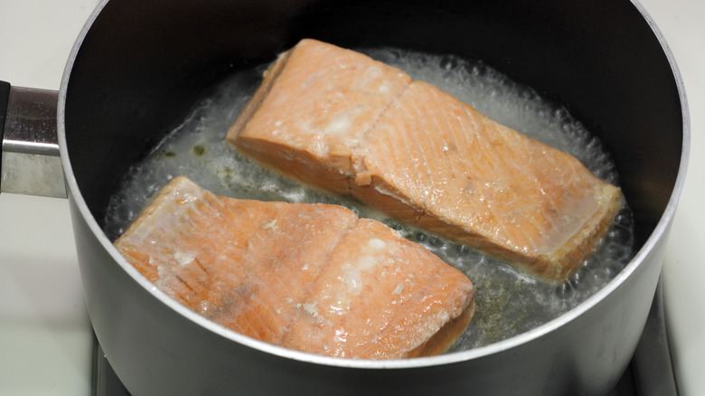wild salmon fillets being poached