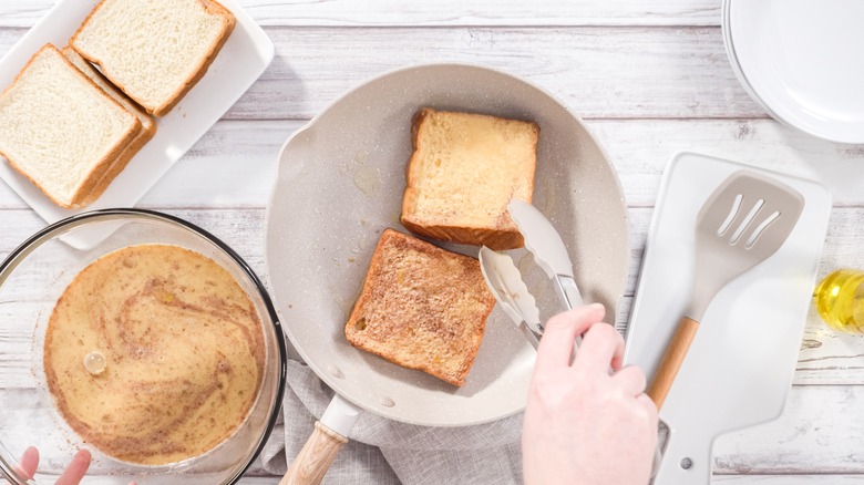 Preparing French toast using slices of Texas toast bread