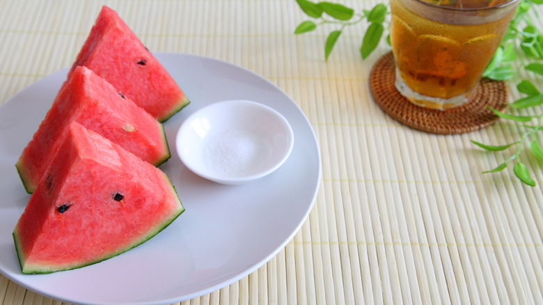 Watermelon slices plated with a small dish of salt