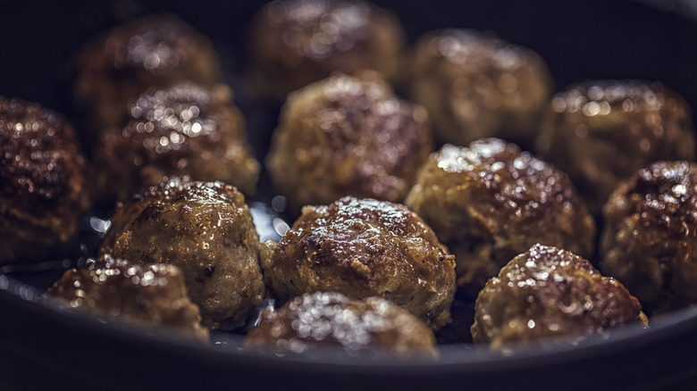 Close up meatballs cooking in pan