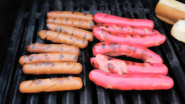 Hot dogs cooking on a grill