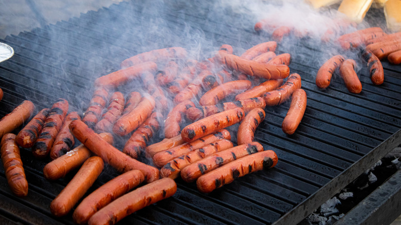 Frankfurters cooking on grill