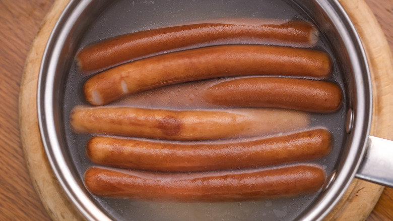 Pan of water, with wieners cooking in it