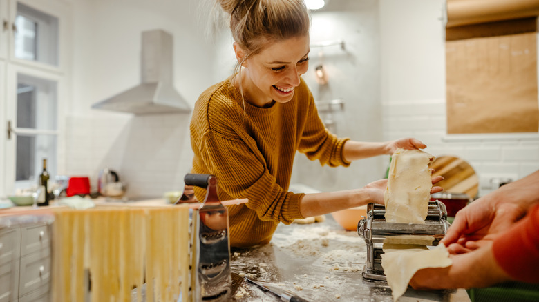 two people making pasta