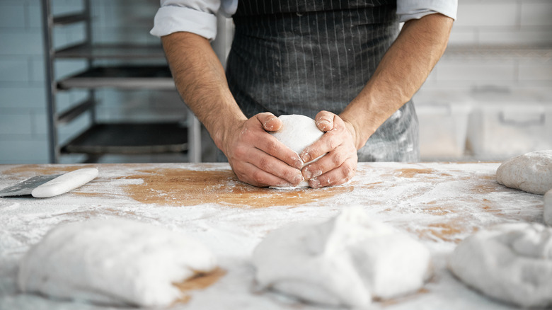 chef kneading dough