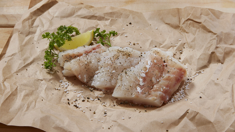 Pieces of cod on paper